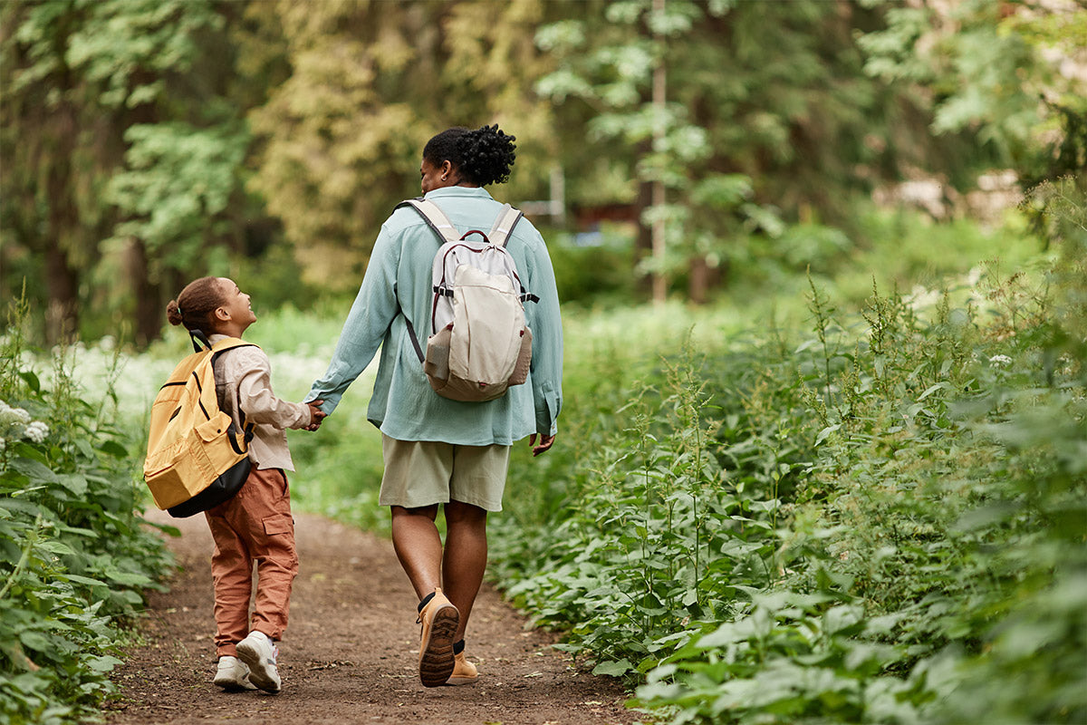Young woman walking in nature with her child.